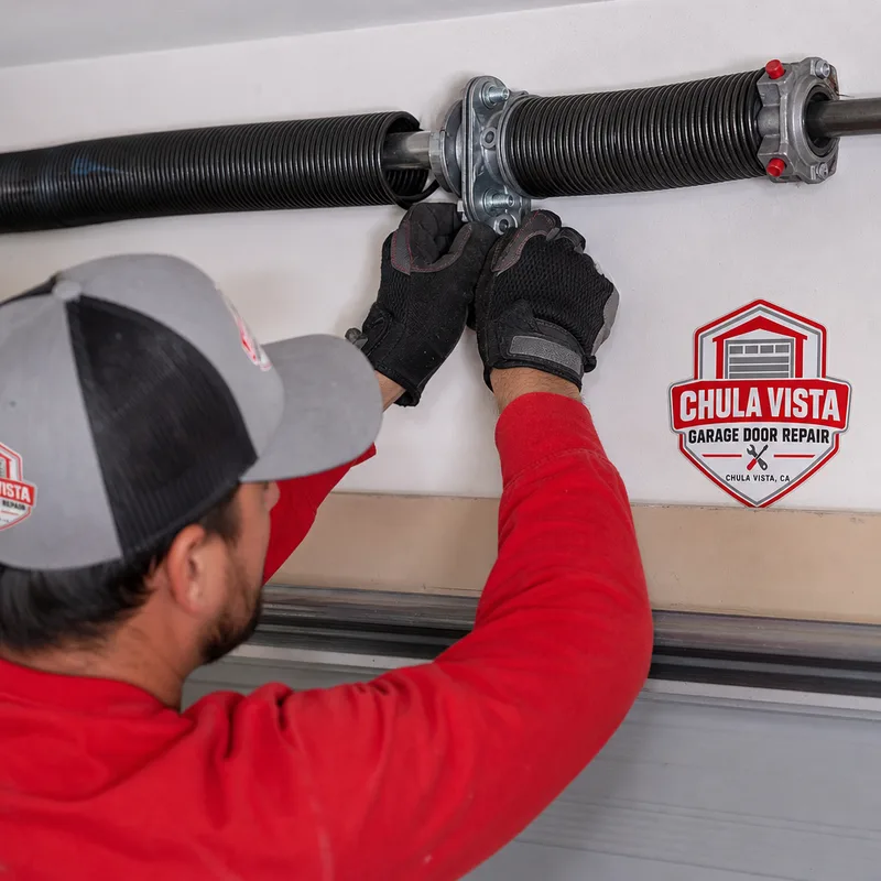 Torsion spring system with center bearing plate and winding cones mounted above a garage door